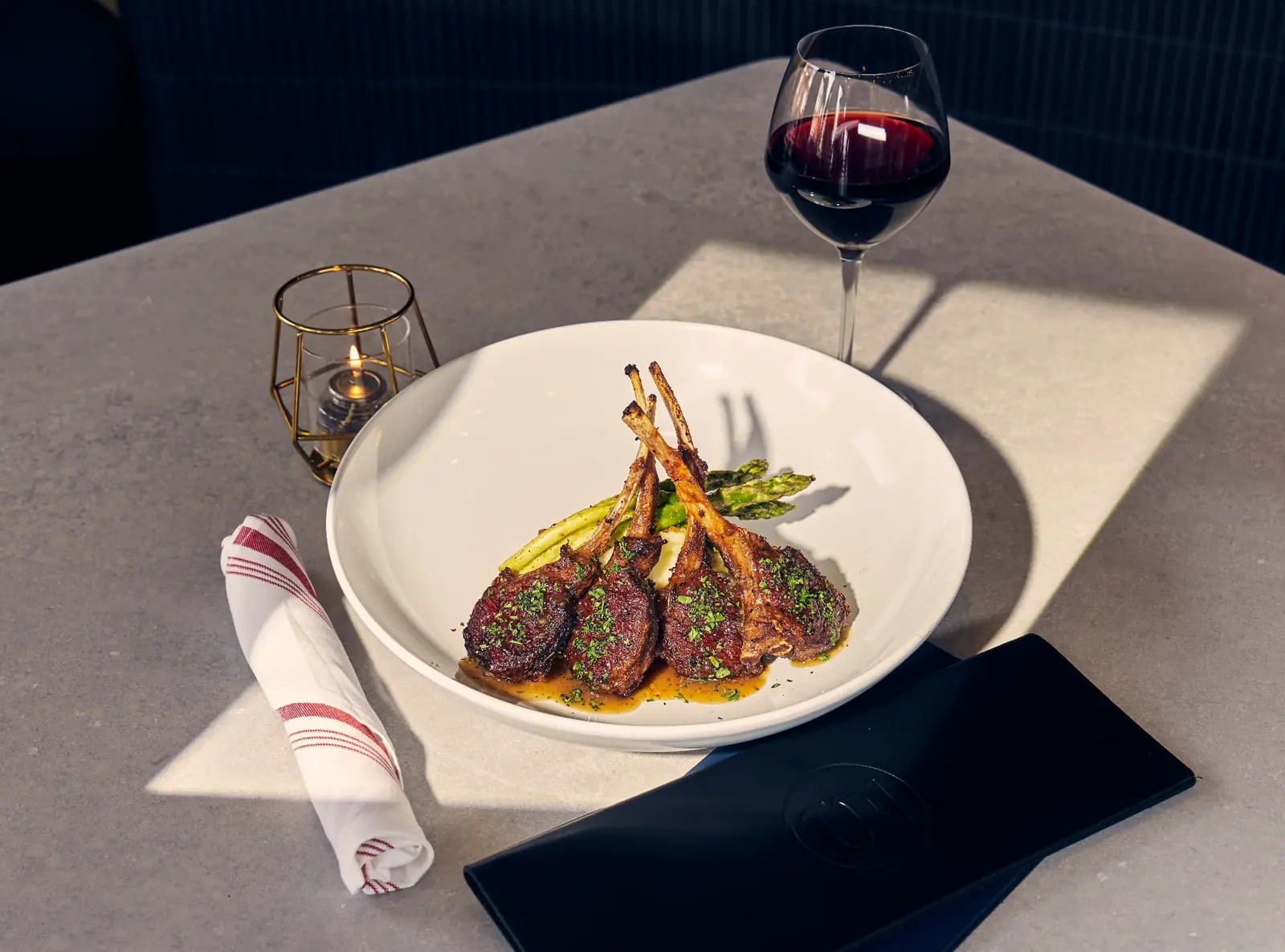 Lamb chops with asparagus and a glass of red wine at Five Corners Ristorante