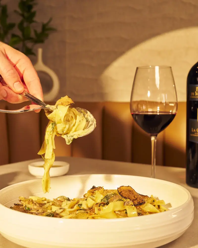 Handcrafted pappardelle with truffle and a glass of red wine at Five Corners Ristorante